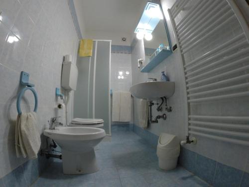 a bathroom with a white toilet and a sink at Il Prato in Predappio