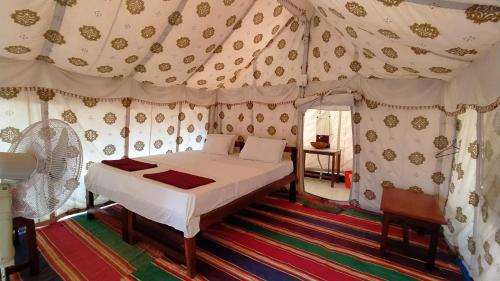 a bedroom with a bed in a tent at Cola Beach Exclusive Resort in Cola