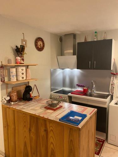 une cuisine avec un îlot en bois au milieu dans l'établissement Appt briancon 4 pers au pied des remontés mécaniques le relais de la guisane, à Briançon