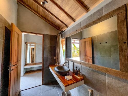 a bathroom with a sink and a mirror at Diamond Beach Villas in Nusa Penida