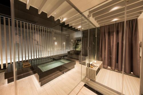 a room with a swimming pool and a glass wall at HOTELみなと-MINATO- in Tokyo