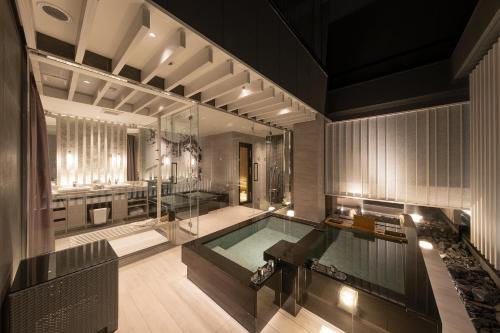 a large bathroom with a swimming pool and a tub at HOTELみなと-MINATO- in Tokyo
