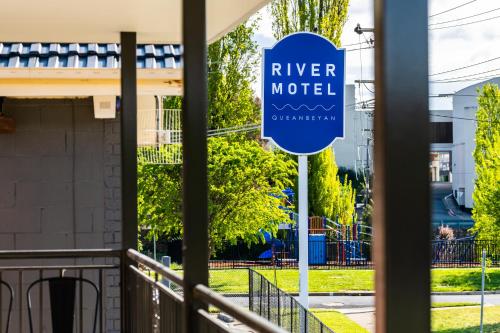 a sign for river motel in front of a building at River Motel in Queanbeyan