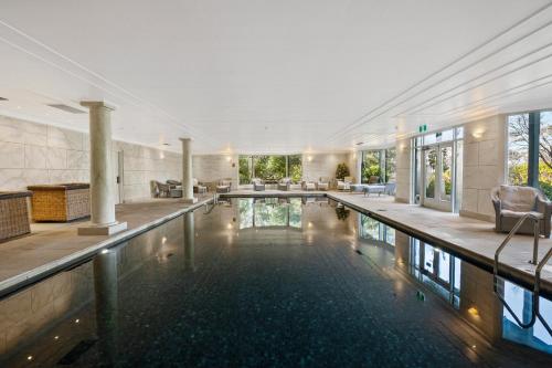 a swimming pool in a large building with a swimming pool at Echoes Boutique Hotel & Restaurant Blue Mountains in Katoomba