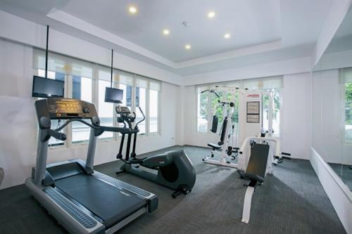 a gym with a treadmill and exercise equipment in a room at Lemansion Senopati in Jakarta