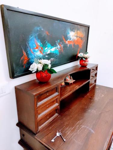 a flat screen tv sitting on top of a wooden entertainment center at Entire Studio Apt/Suite near Mall/Metro/ExpoMart in Noida