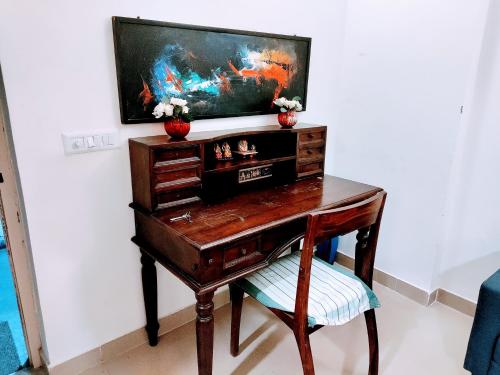 a desk with a television on top of it at Entire Studio Apt/Suite near Mall/Metro/ExpoMart in Noida
