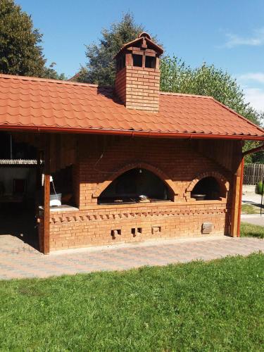 a large brick building with a tower on top at CASUTA CU FLORI in Vîlcele