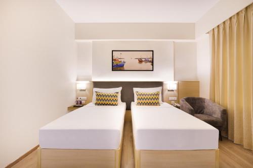 Postel nebo postele na pokoji v ubytování Keys Lite By Lemon Tree Hotels Sreekanya