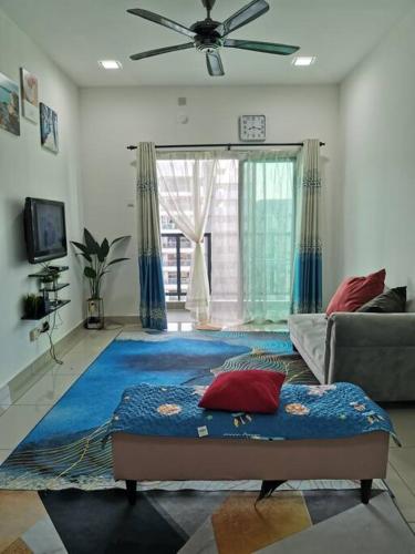 a living room with a bed and a couch at Zanra Homestay at Residensi Zamrud Blok B in Kajang