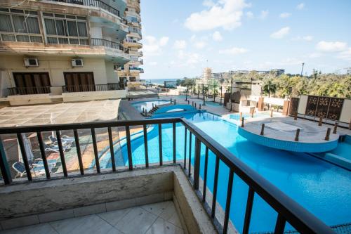 a view of the pool from the balcony of a hotel at AIFU Hotel El Montazah Alexandria in Alexandria