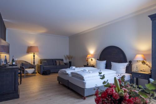 um quarto com uma cama e uma sala de estar em Ravensberger Hof em Bielefeld