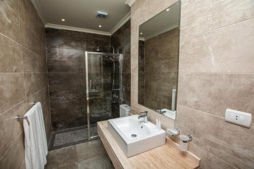 a bathroom with a sink and a shower at AIFU Hotel El Montazah Alexandria in Alexandria