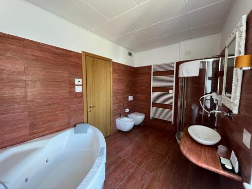 a bathroom with a tub and a toilet and a sink at Domus Stella Maris - Casa per Ferie in Ancona