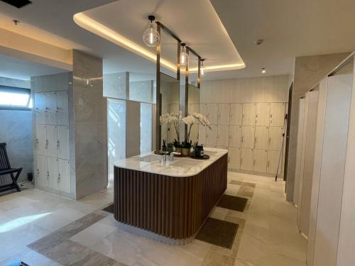 a bathroom with a counter with flowers on it at Astra Sky River Condo in Chiang Mai