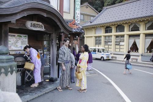 a group of people standing outside of a building at Kinosaki Yamamotoya in Toyooka
