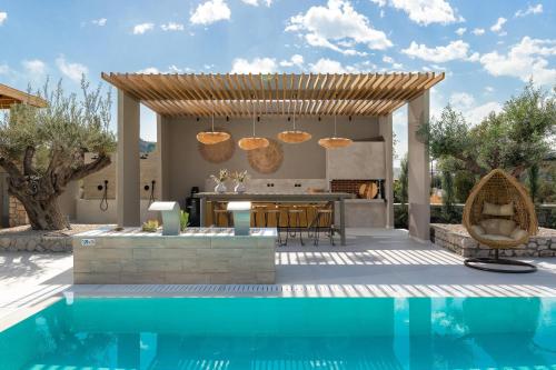 a kitchen and a swimming pool with a villa at Casa di Maria in Afantou