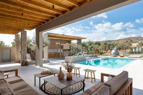 a villa with a swimming pool and a patio at Casa di Maria in Afantou