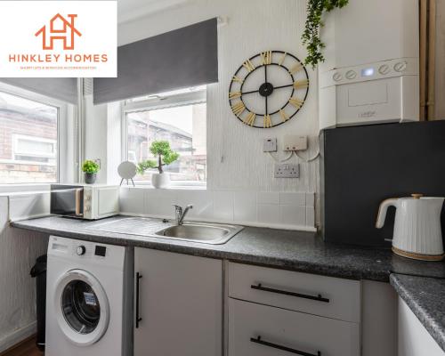 a kitchen with a sink and a washing machine at Stanley House - 7 doubles! - Parking! - City Links By Hinkley Homes Short Lets & Serviced Accommodation in Liverpool