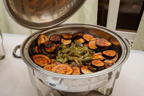 a pot full of food on a stove at AIFU Hotel El Montazah Alexandria in Alexandria