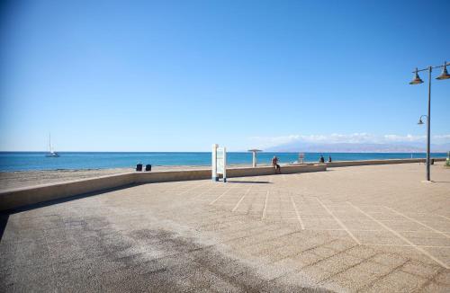 a beach with people and the ocean in the background at Apartamento La Pergola Cabo de Gata in El Cabo de Gata