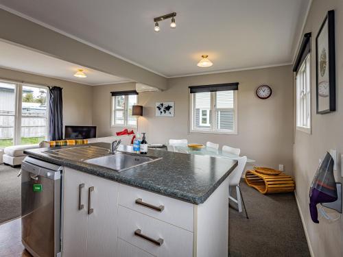 a kitchen with a sink and a living room at Mount Vista - National Park Holiday Home in National Park