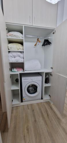 a laundry room with a washing machine and towels at VISAJ Homes in Timişoara
