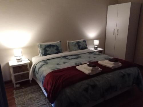 a bedroom with a bed with towels on it at 10 on Fairview B&B in Paarl