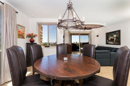 a dining room with a wooden table and chairs at Bella Sirena Beauty 201-C - Stunning Views & Beachfront Bliss in Puerto Peñasco