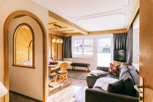 a living room with a couch and a table at Landhaus Perktold in Nesselwängle