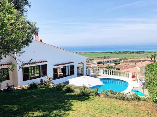 een huis met een zwembad aan de oceaan bij VILLA MARIA vistas al mar y piscina privada in Son Bou