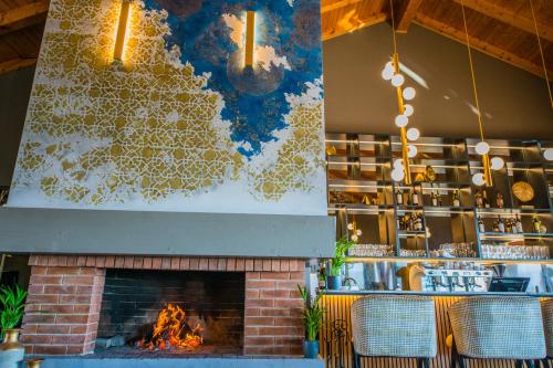 a fireplace in a restaurant with a fire place at Pensiunea Casa Buna in Gîrbova