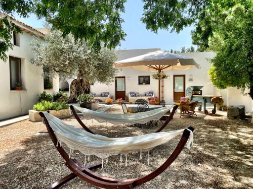a couple of hammocks sitting in a yard at Villa Angelina - charming rooms & apartments in Trapani
