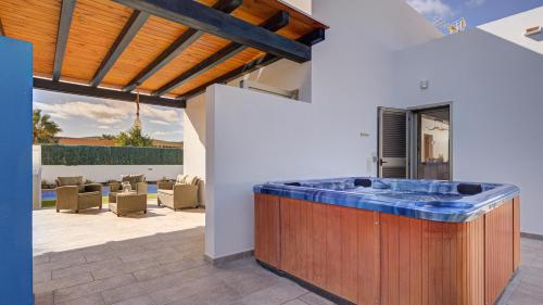 an outdoor kitchen with a blue counter in a house at Villa Melissa in Costa de Antigua