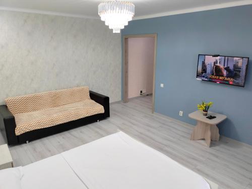 a living room with a couch and a tv at ЖК комфорт in Kokshetau
