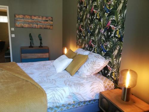 a bedroom with a bed with a large mural on the wall at Appartement sous les remparts in Carcassonne