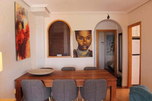 une salle à manger avec une table et un tableau mural dans l'établissement Casa Azul, à Alicante