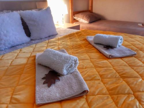 a bed with two towels and pillows on it at Dionis in Veliko Gradište