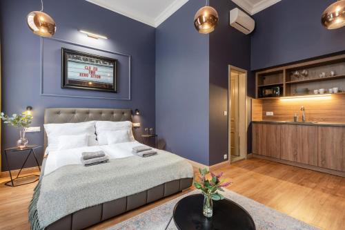 a bedroom with purple walls and a bed with a table at The Pearl of the Heart of Budapest in Budapest