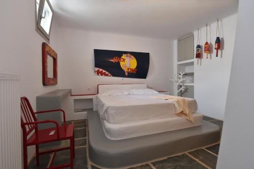 a bedroom with a bed and a desk and a chair at Villa Oliviers · Deluxe Villa - Infinity Pool & Helipad in Naousa