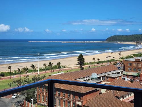 a view of a beach and the ocean from a balcony at Sea Views at 10 South in Durban
