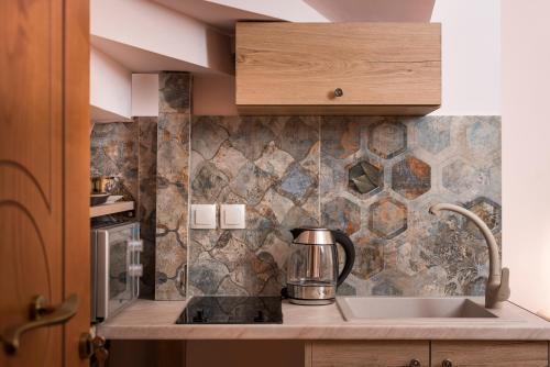 a kitchen with a sink and a counter top at Palazzo di Irene in Chania Town