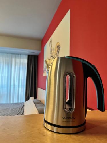 a tea kettle sitting on a table in a bedroom at Appartamento Moderno Torino San Salvario in Turin
