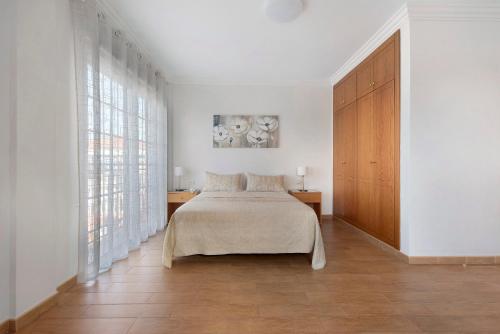 a bedroom with a bed and a large window at Casa Luz in La Luz