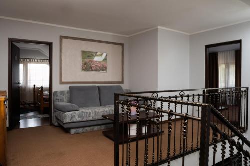 a living room with a couch and a staircase at Pensiunea Lido Moisei in Moisei