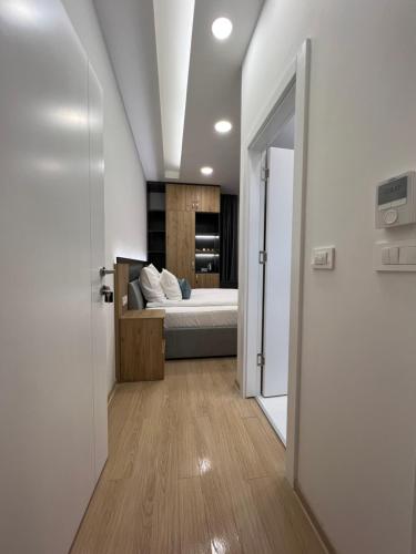 a bedroom with a bed in a room with a door at OLYMPIC 84 Apartments in Sarajevo