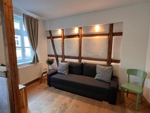 a living room with a couch and a green chair at Stella Apartments in Erfurt