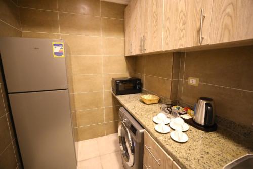 a small kitchen with a dishwasher and a sink at Marom Port Said Resort & Beach in Port Said