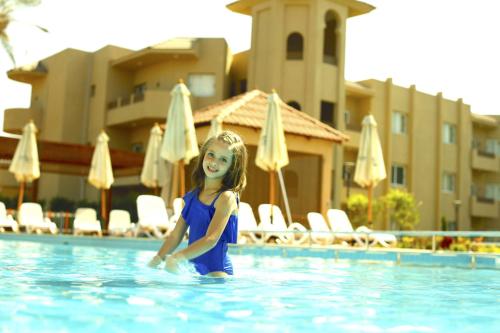 a little girl in the swimming pool at a hotel at Marom Port Said Resort & Beach in Port Said