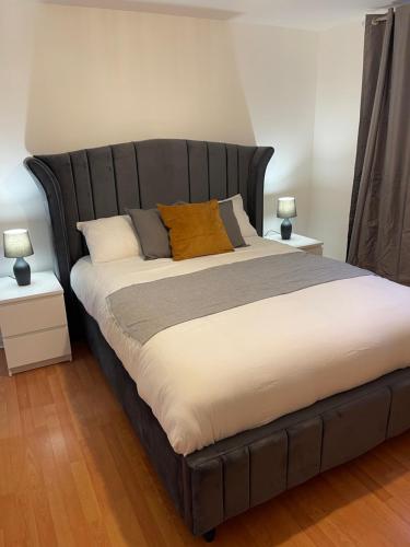 1 dormitorio con 1 cama grande y 2 mesitas de noche en Entire 2 bedroom Beautiful newly furnished flat en Glasgow